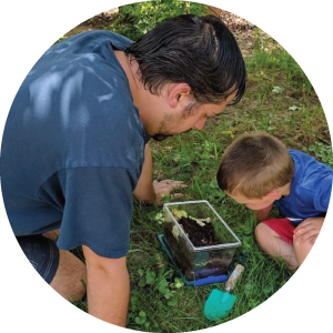 Dad and child looking at bug outside