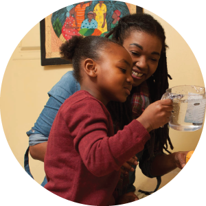 Mother and child at sink