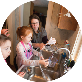 Family with funnels at sink