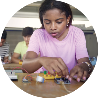 A girl works with electronics