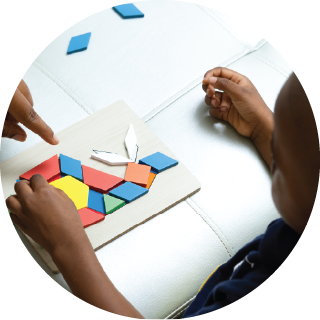 Boy playing with pattern blocks