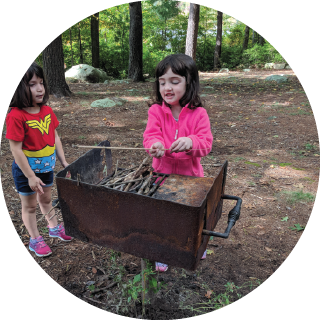 Two girls gather wood