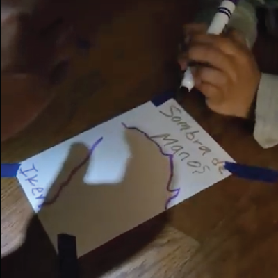 parent traces shadows of child's hands