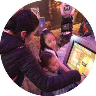 Mother and child at a museum kiosk screen