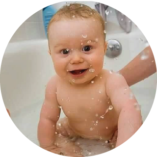A baby plays in the bath