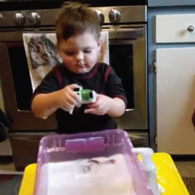 Toddler playing in water tub
