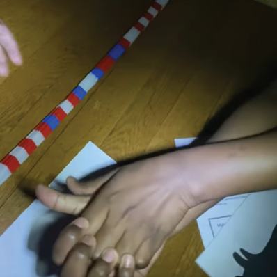 Mom and sibling help child make hand shadows