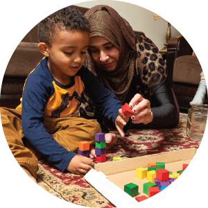 Mother and child playing with large colored bricks