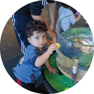 Boy with a ball near a water tank