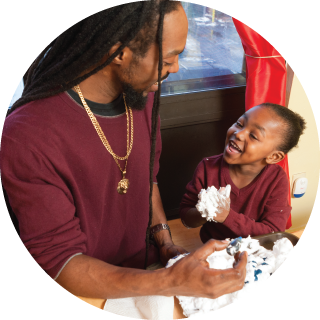 Dad and child playing with shaving cream
